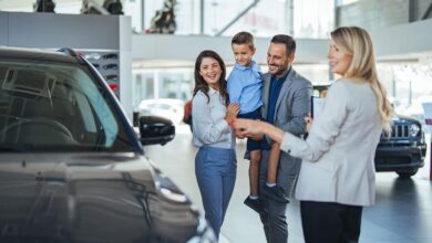 Car dealership in Aurora Colorado displaying vehicles with customers comparing models and dealership services