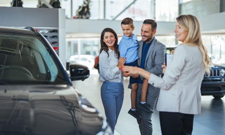 Car dealership in Aurora Colorado displaying vehicles with customers comparing models and dealership services